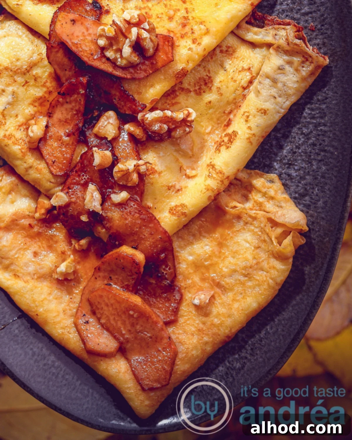 An aerial view with a gray scale on a leaf background with a macro magnification of crepes with caramel sauce and baked apples