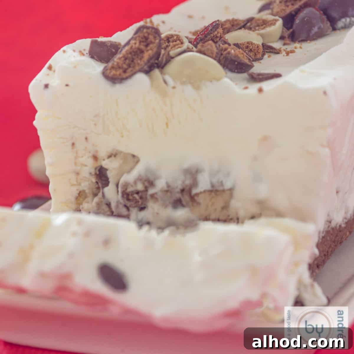 Dutch Pepernoten Holiday Ice Cream Dream 4 A square photo of an ice cream cake with chocolate gingerbread nuts. A slice cut off.