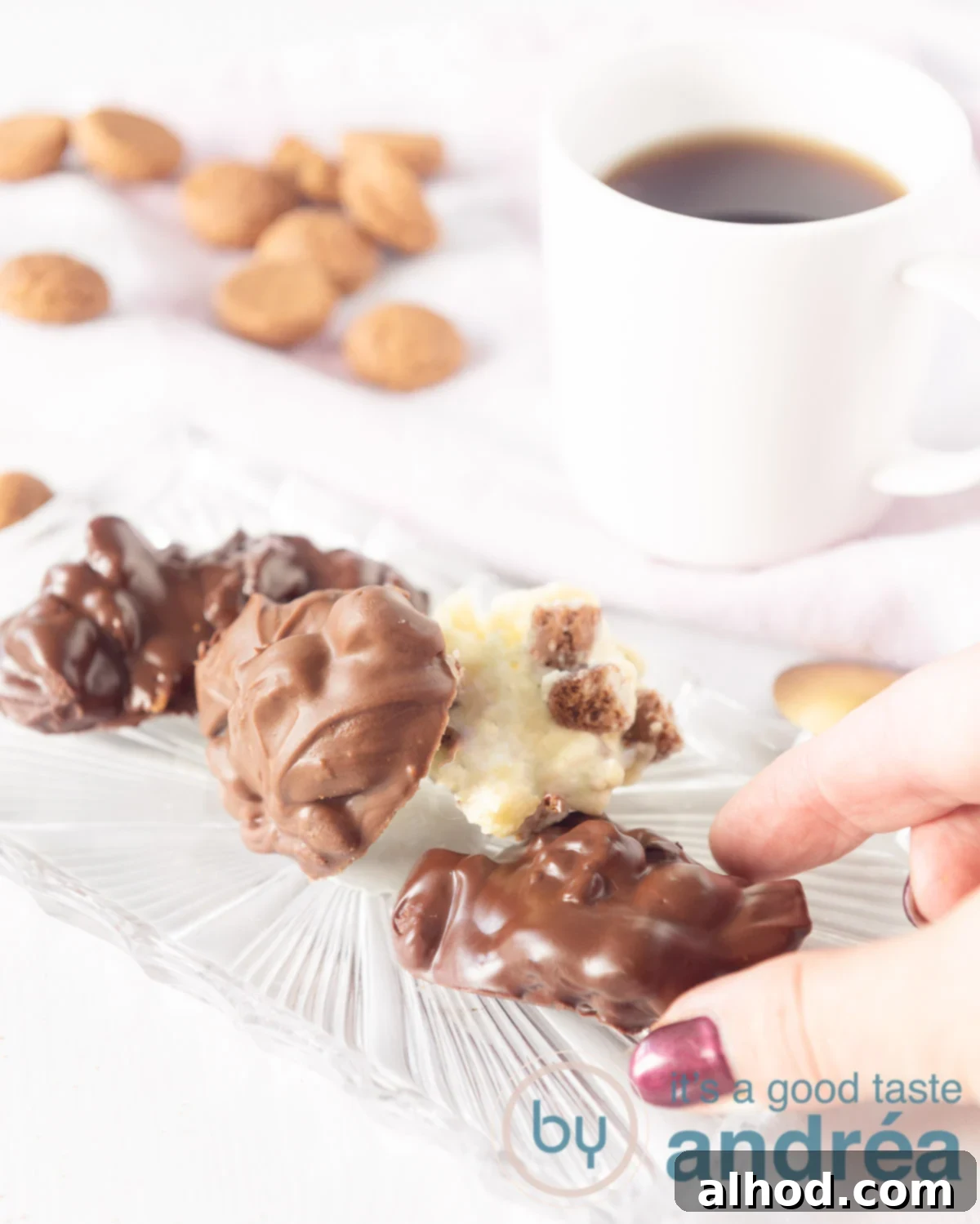 Spiced Pepernoten Chocolate Discs 5 Three different kinds of pepernoten chocolate on a white backdrop with pepernoten around them and a cup of coffee in the back