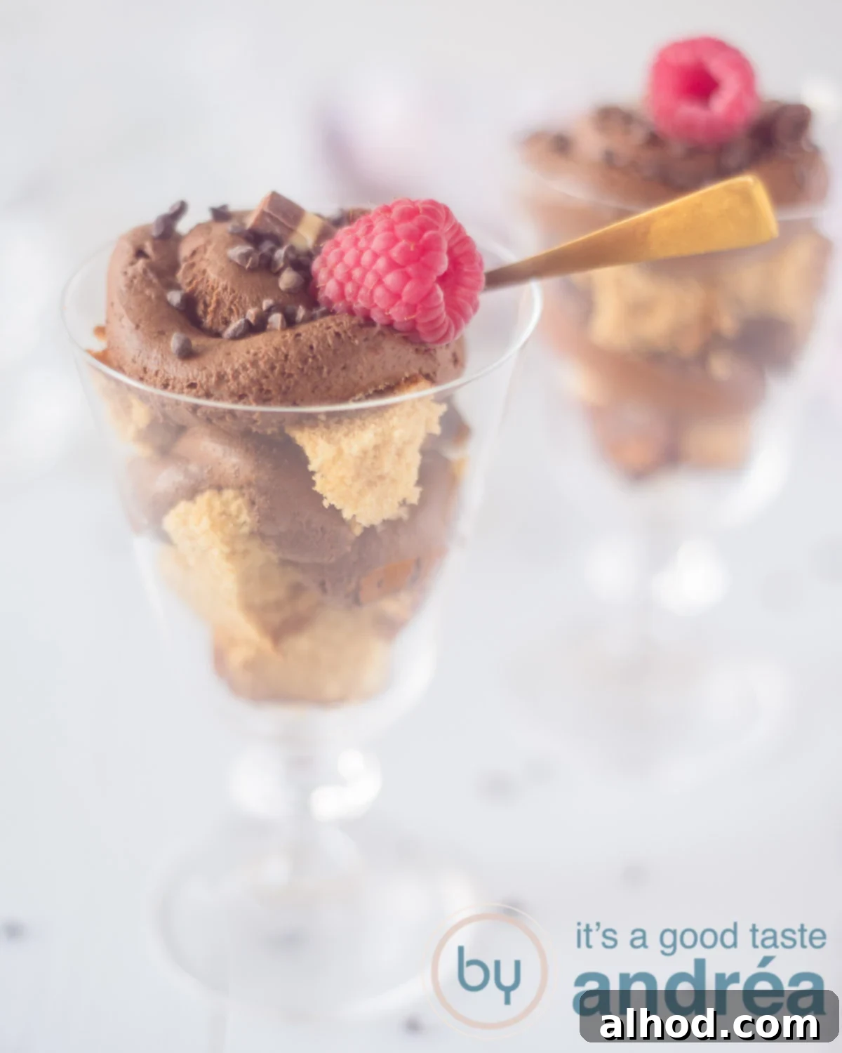 Decadent Chocolate Mousse Trifle 5 Chocolade mousse trifle, showcasing the beautiful layers in a glass with a berry on top.