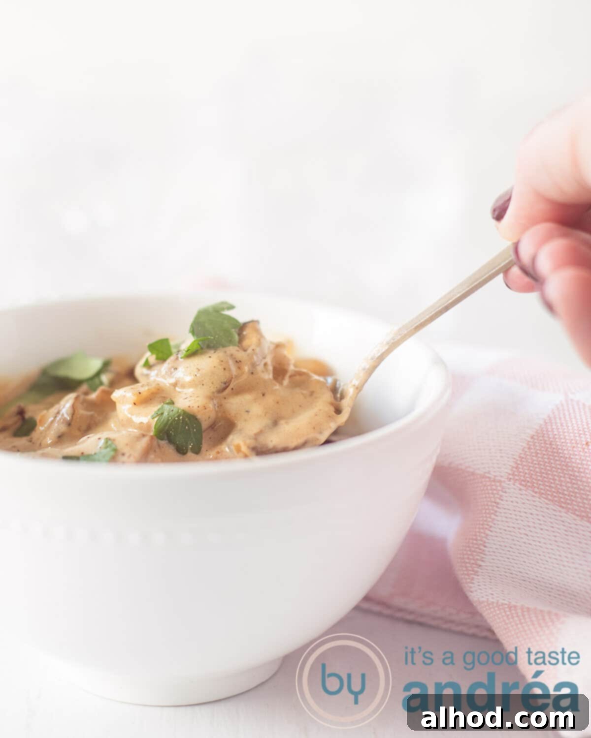 A bowl filled with mushrooms in a cream sauce with white wine