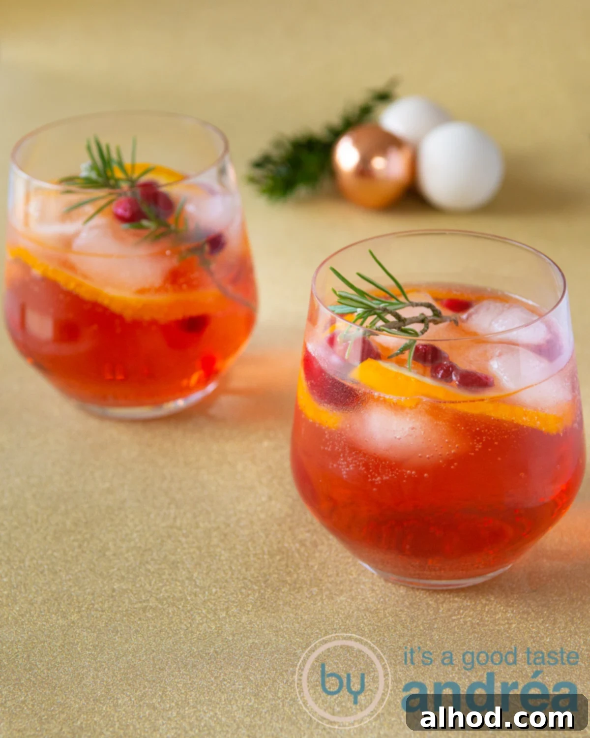 Festive Christmas Punch 2 Festive Christmas Punch with orange, cranberries, and rosemary garnish in a glass