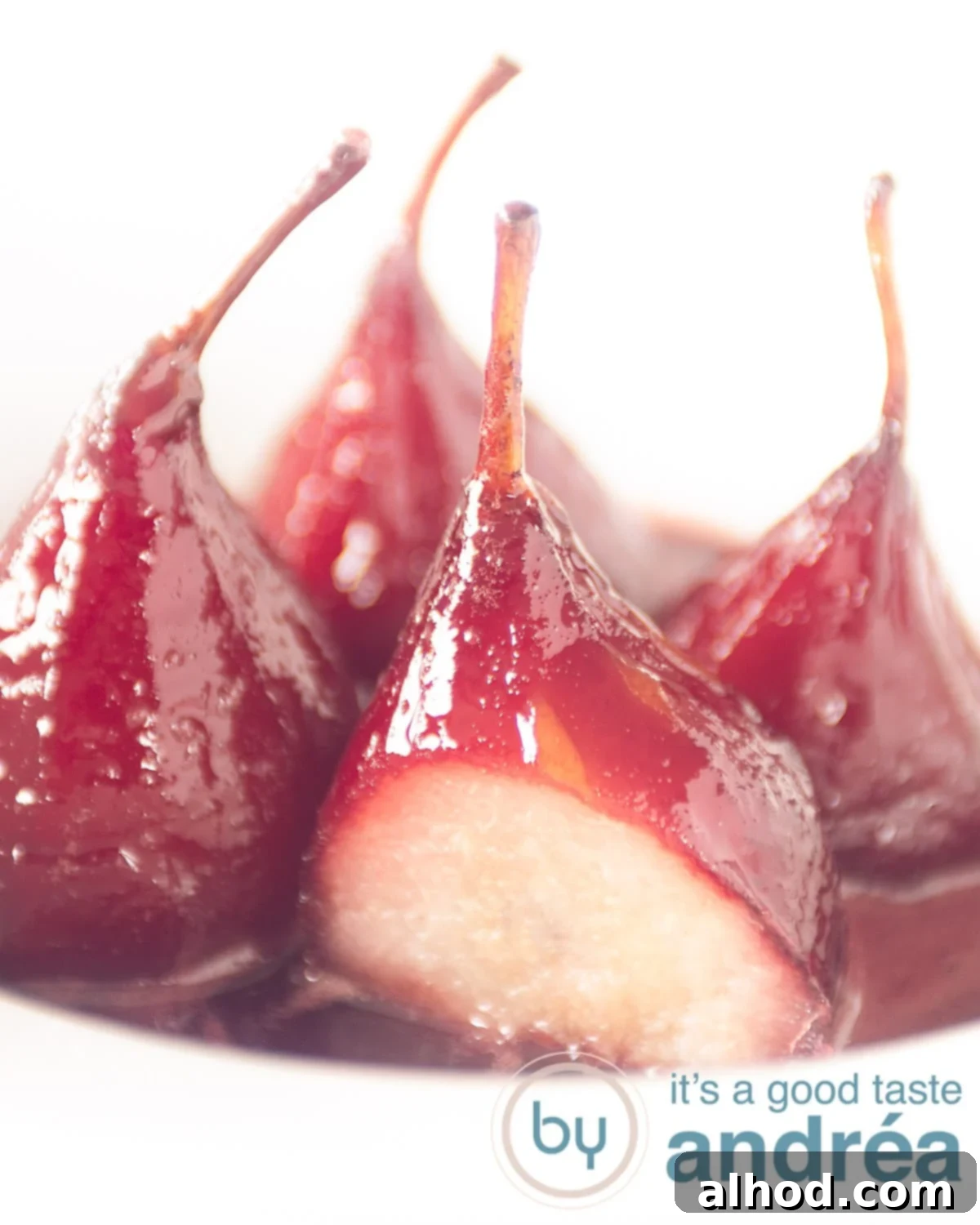 Effortless French Port Wine Poached Pears 5 4 stewed Pears au vin rouge aka poached pears with syrup in a white deep plate