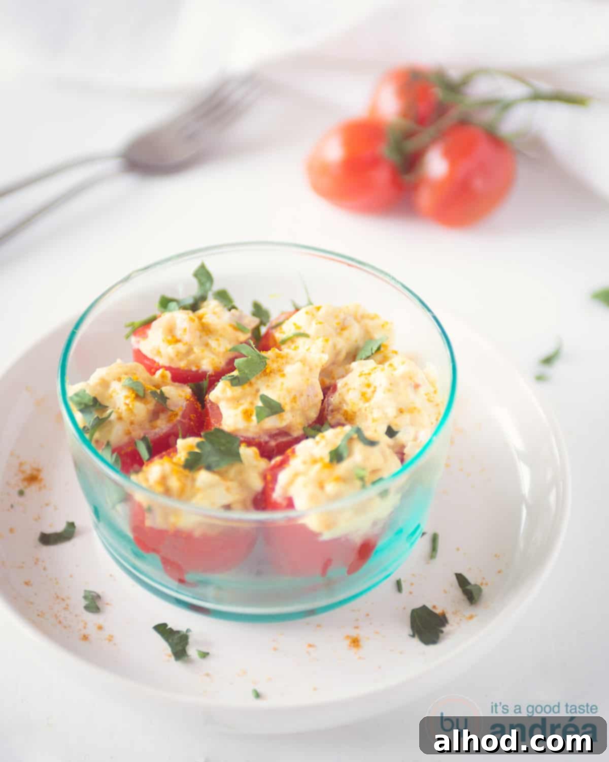 Creamy Egg Salad Tomato Boats 2 A vibrant display of cherry tomatoes generously stuffed with creamy, homemade egg salad and garnished with fresh green chives, artfully arranged in a rustic bowl, ready to be served as an irresistible appetizer.