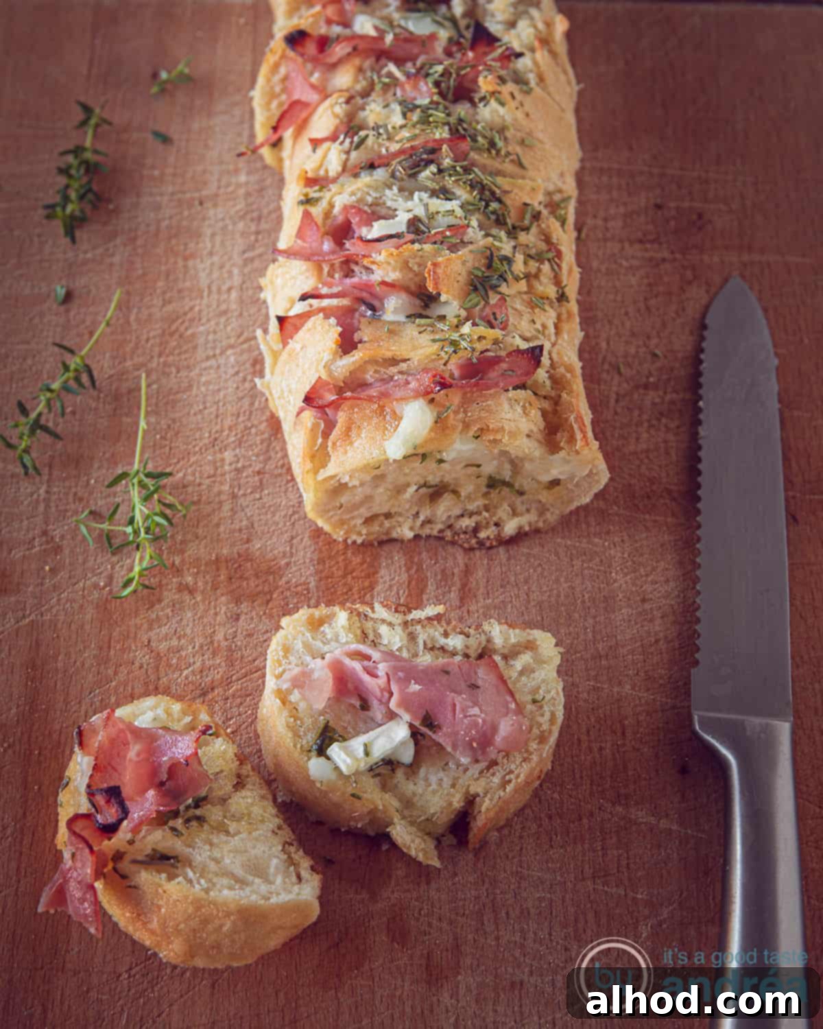 Toasted Baguette with Goat Cheese, Garlic, and Ham 3 Close-up of baked baguette with melted goat cheese and ham