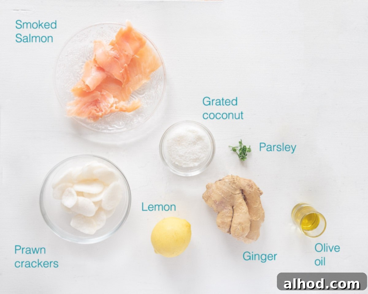Salmon and Crispy Prawn Crackers 3 Individual ingredients for Prawn Crackers with Salmon, including smoked salmon, prawn crackers, ginger, lemon, olive oil, coconut, and parsley, neatly laid out on a white background.