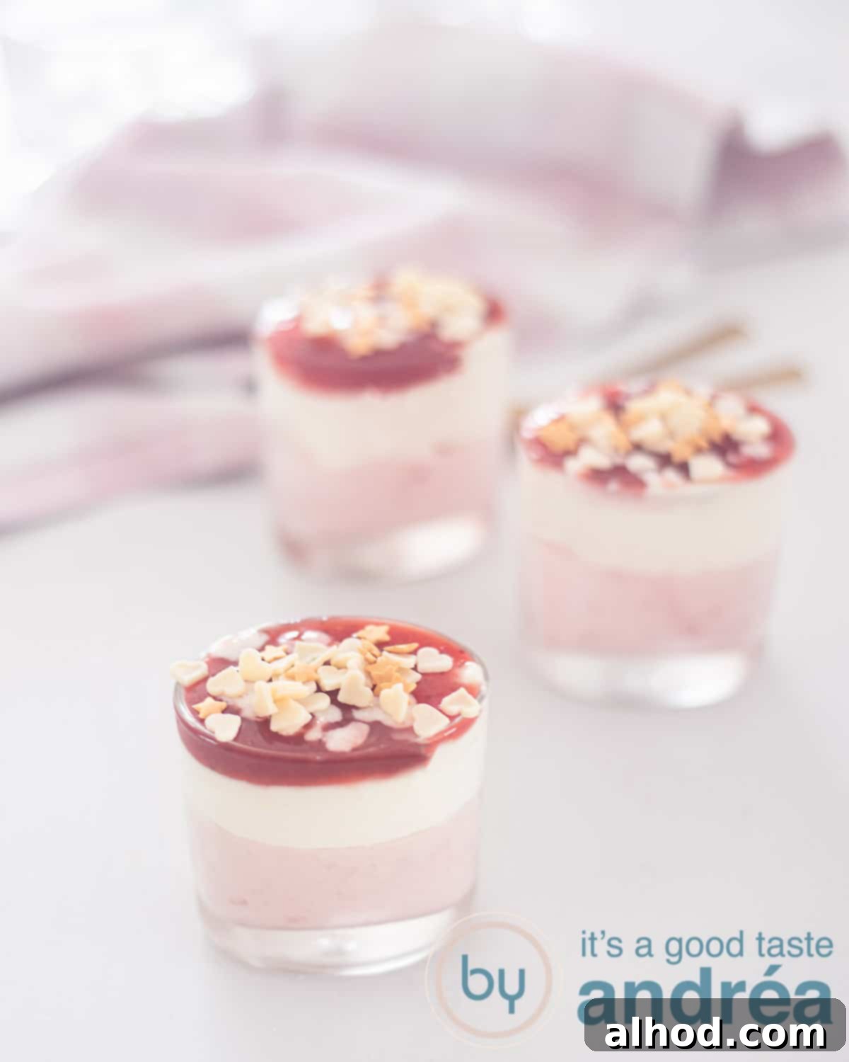 Decadent White Chocolate Strawberry Mousse 2 An height photo with white chocolate mascarpone mousse with strawberry mousse and a jam topping.