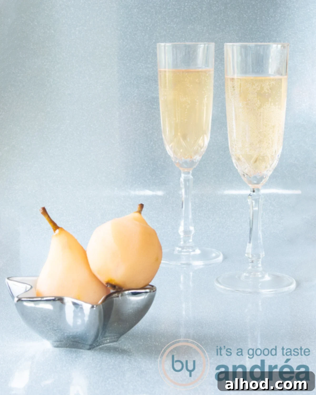 Sparkling Pear Elixir 5 Two delicious stewed pear champagne cocktails in the background. In the foreground a bowl with stewed pears.
