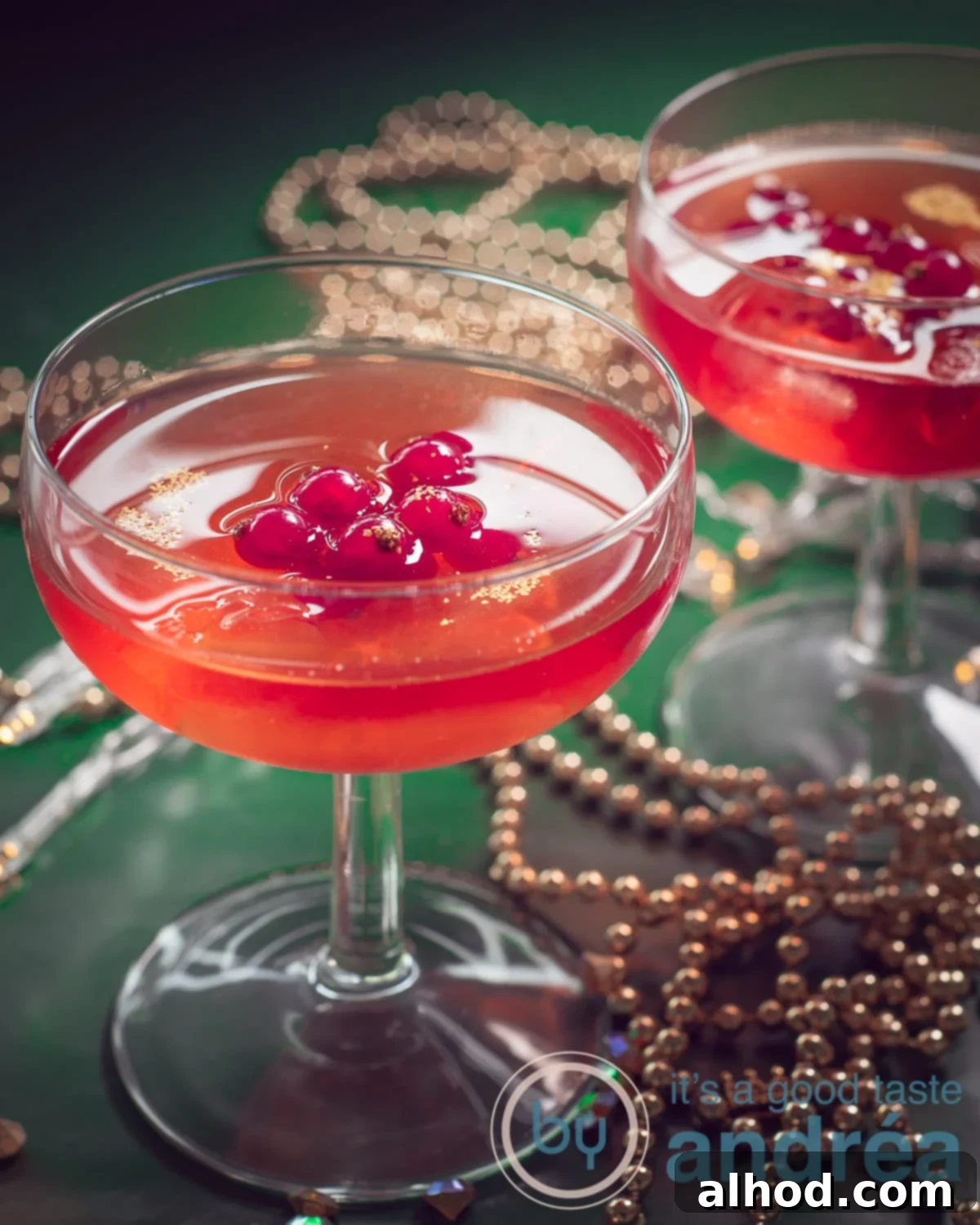 Two glasses filled with Cosmopolitan cocktail recipe with red currants, offering a vibrant and fruity twist on a classic.