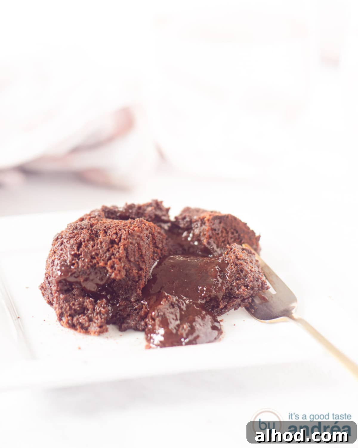 Molten Chocolate Puddings 3 A ramekin with a perfectly baked chocolate pudding featuring a luscious liquid heart.
