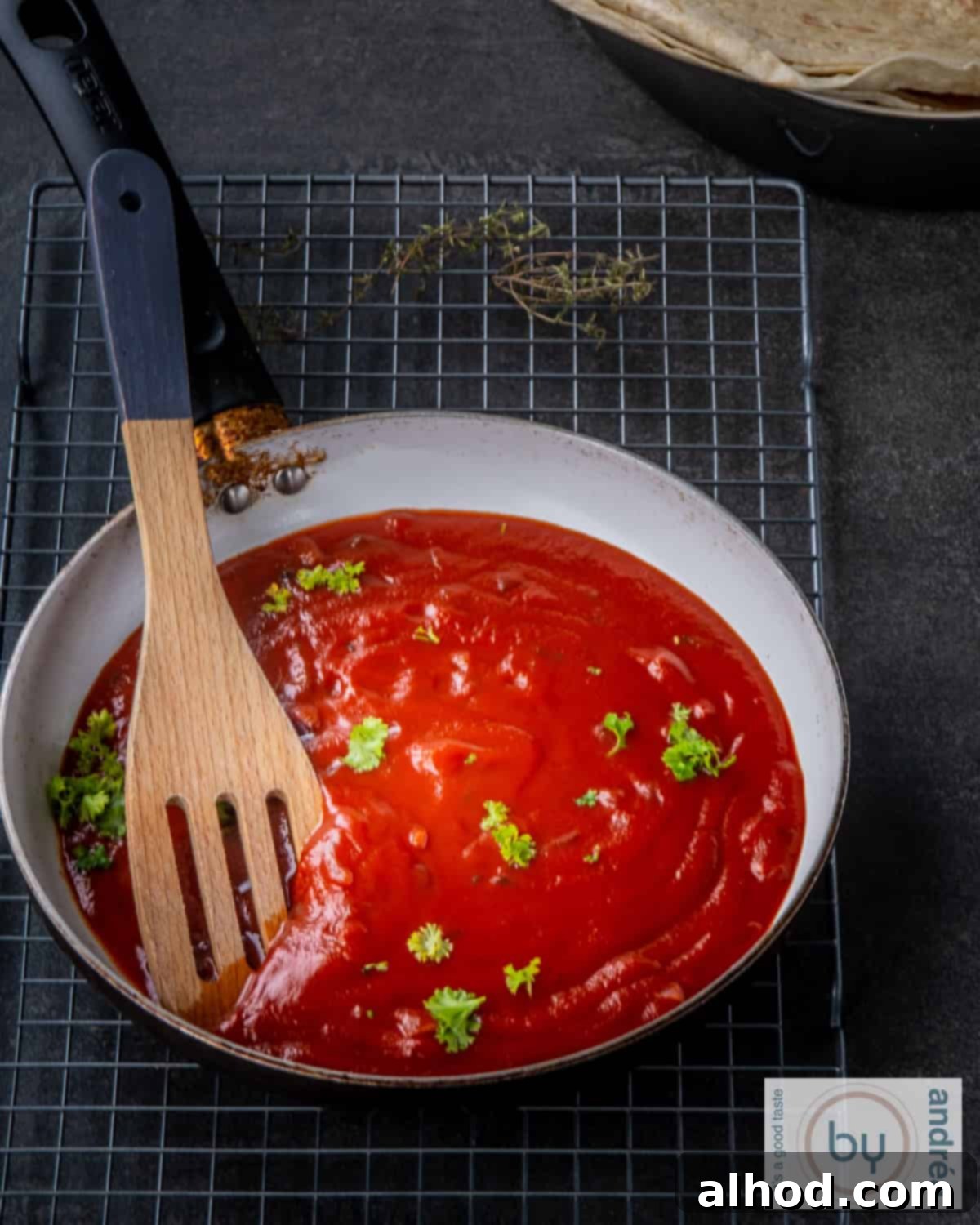 Homemade Enchilada Sauce 2 Delicious homemade enchilada sauce simmering gently in a rustic skillet, ready to be incorporated into your favorite Mexican recipes.