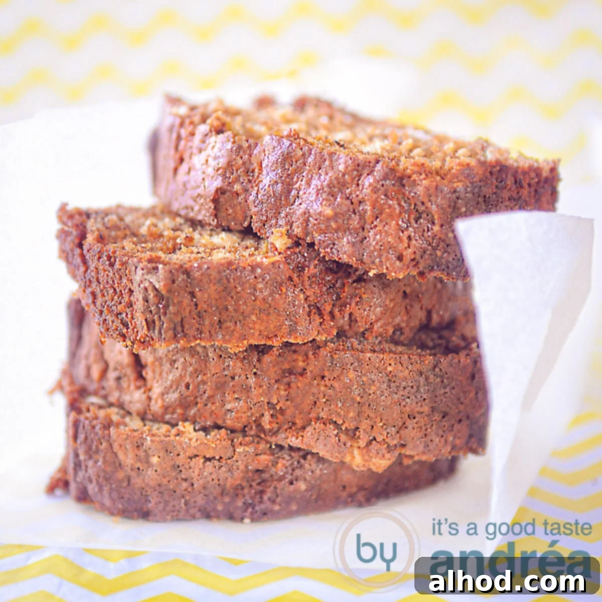Golden Banana Pound 5 A square photo with 4 slices of stacked banana cake on a white baking paper, set against a yellow-white background. This image showcases the moist and delicious outcome of the banana loaf pound cake recipe.