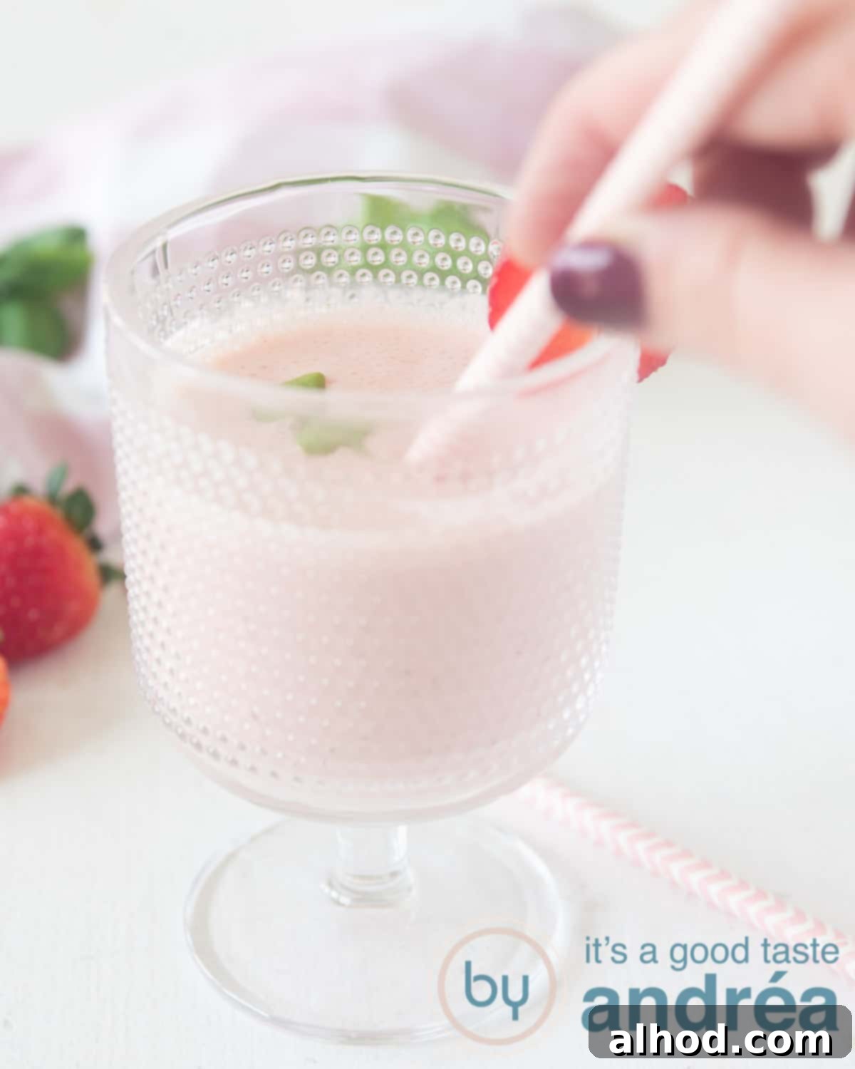 Sweet and Savory Strawberry Basil Smoothie 4 a glass with strawberry basilicum smoothie and a pink straw