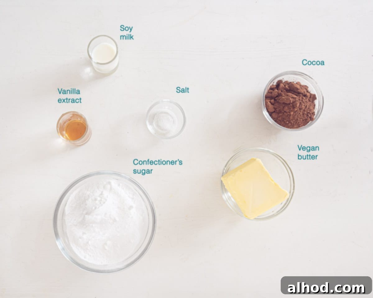 Easy Dairy-Free Chocolate Cupcakes 4 Individually labelled ingredients for luxurious vegan chocolate topping, including room-temperature plant-based butter, confectioners' sugar, rich cocoa powder, vanilla extract, a pinch of salt, and soy milk, neatly arranged on a white background.