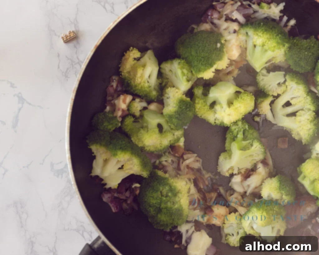 Herby Broccoli Frittata with Melted Mozzarella 4 Step 2: Sautéing onions and garlic, then mixing in broccoli and mozzarella cubes.