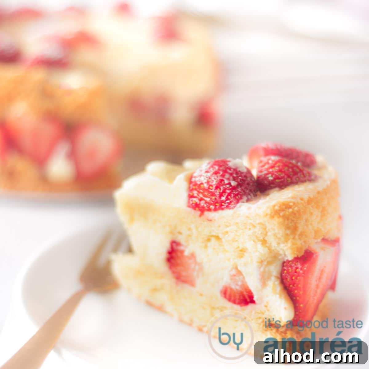 Cloud-Soft Strawberry Chiffon 8 Square photo with a piece of chiffon cake with strawberries on a white plate. In the background the rest of the cake