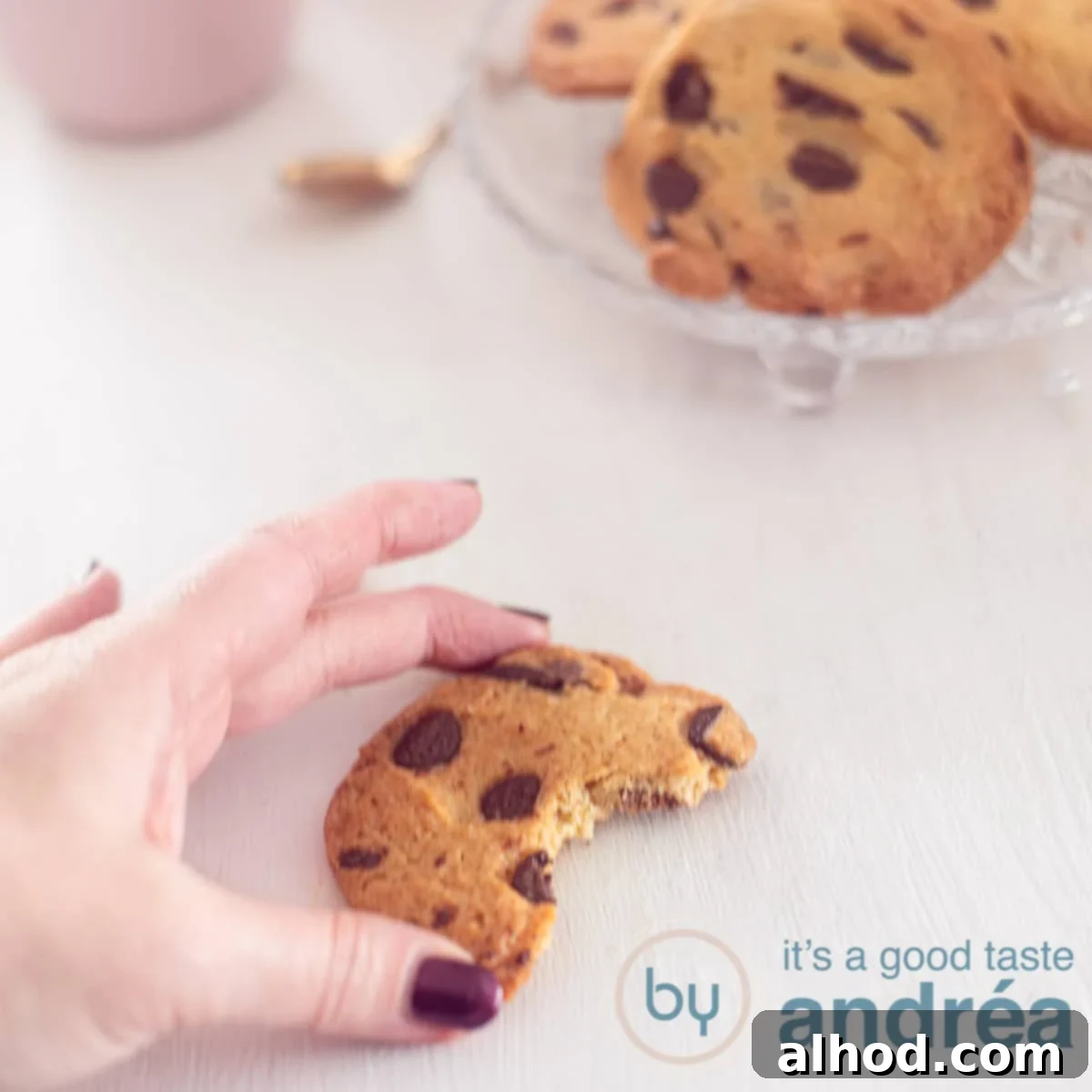 Your Personal Small Batch Chocolate Chip Treat 6 A square photo with half a cookie holding a hand. A white background. Top right a bowl with chocolate chip cookies.