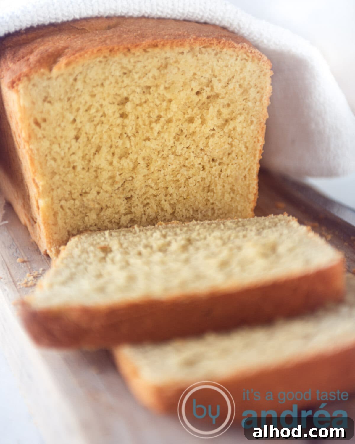 Easy Scratch-Made Vegan Cornbread Loaf 8 cornbread loaf and some slices cut of on a white plate