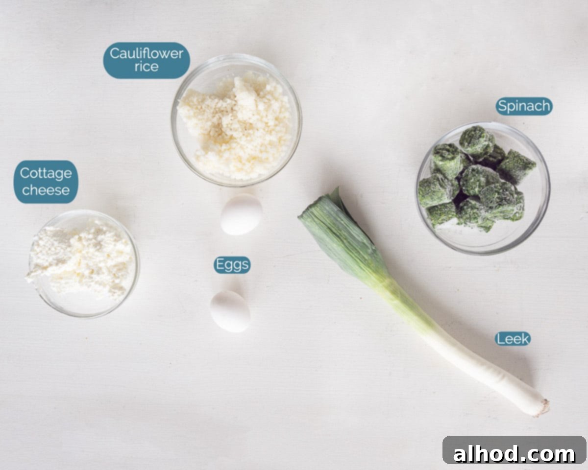 Velvety Cauliflower Rice with Spring Greens 3 A collection of ingredients for Creamy Cauliflower Rice with Spinach and Leek, clearly labeled and arranged on a clean white background.