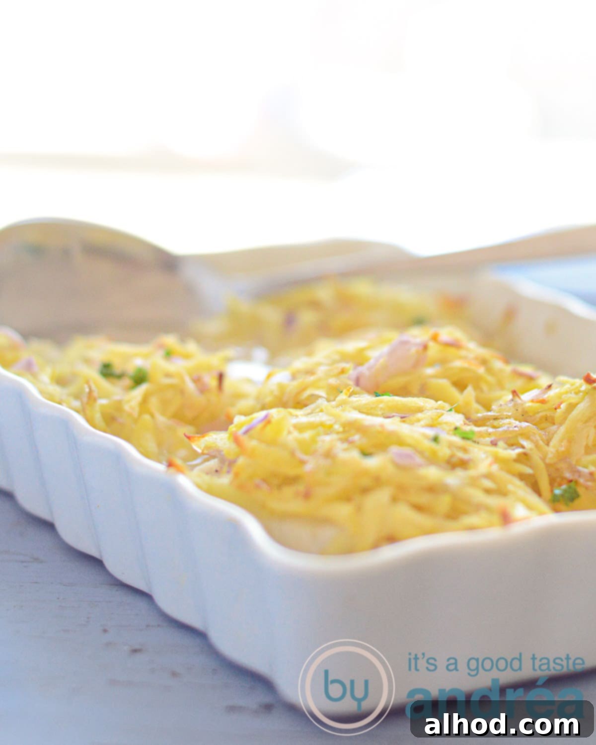 Hearty Cod and Potato Bake 5 A close-up of a rustic cod and rösti casserole, with the golden potato topping and creamy fish visible in the serving dish.
