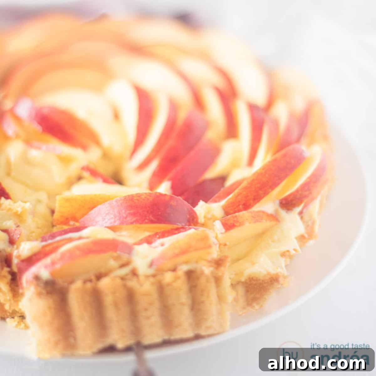 Rose Apple Delight 4 A square photo with part of an apple rose cake, one point cut out. A white background