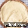 Pie dough filled with pastry cream that is smoothed with a palette knife