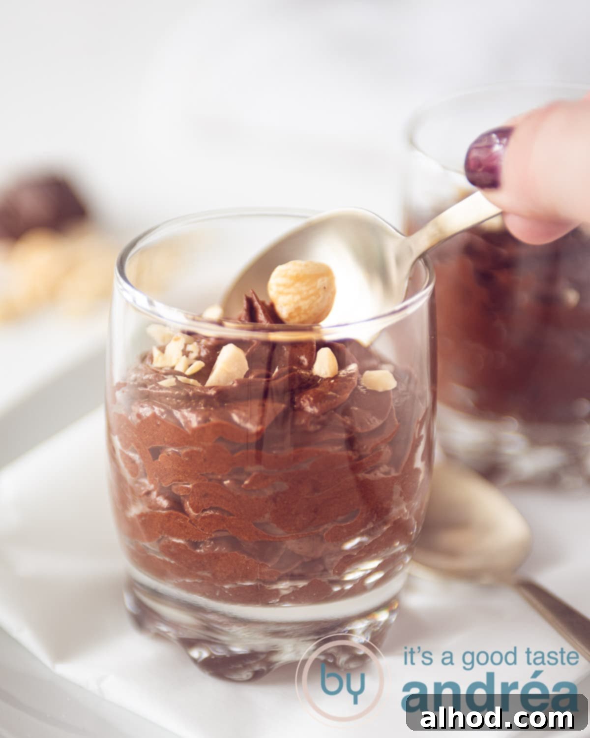 Dreamy Chocolate Mousse (No Cream Needed) 9 A hand which takes a bite of chocolate mousse