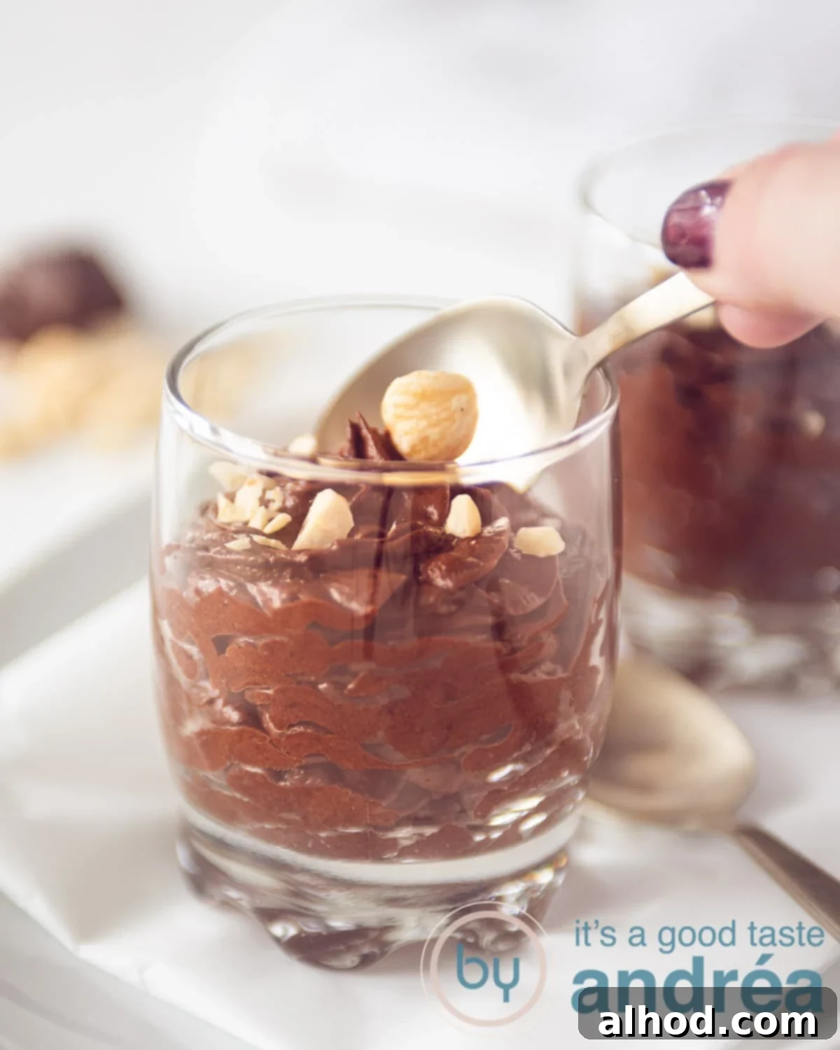 Dreamy Chocolate Mousse (No Cream Needed) 10 A hand which takes a bite of chocolate mousse