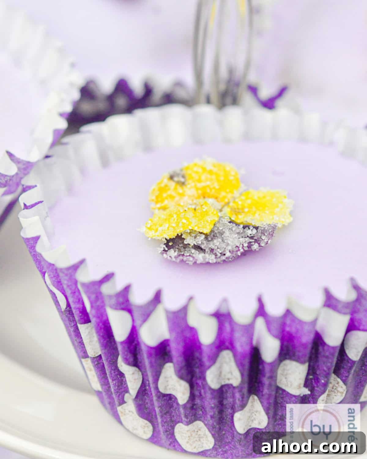 Enchanting Lavender Chocolate Cupcakes 2 Lavender cupcakes decorated with delicate sugar flowers on a white background, highlighting the subtle purple icing and floral accents.