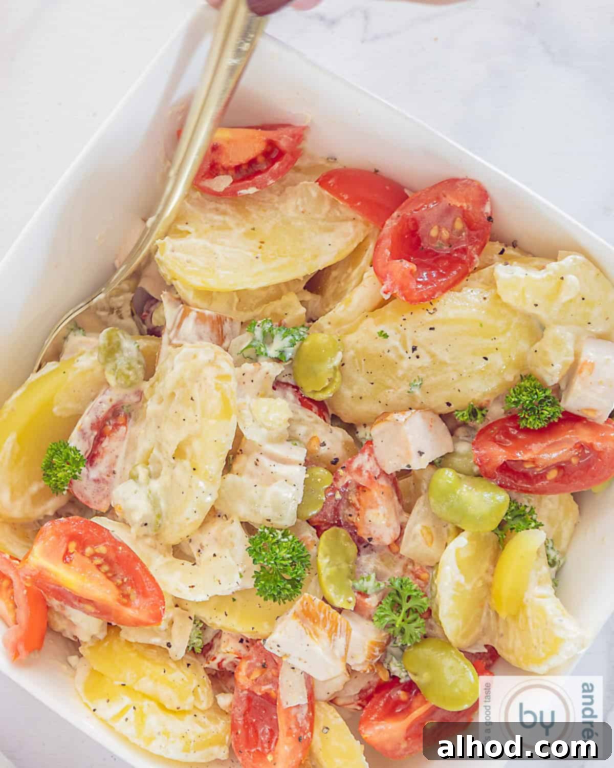Smoky and Creamy Chicken Potato Salad 3 A photo from above of a bowl of lean potato salad with lots of vegetables