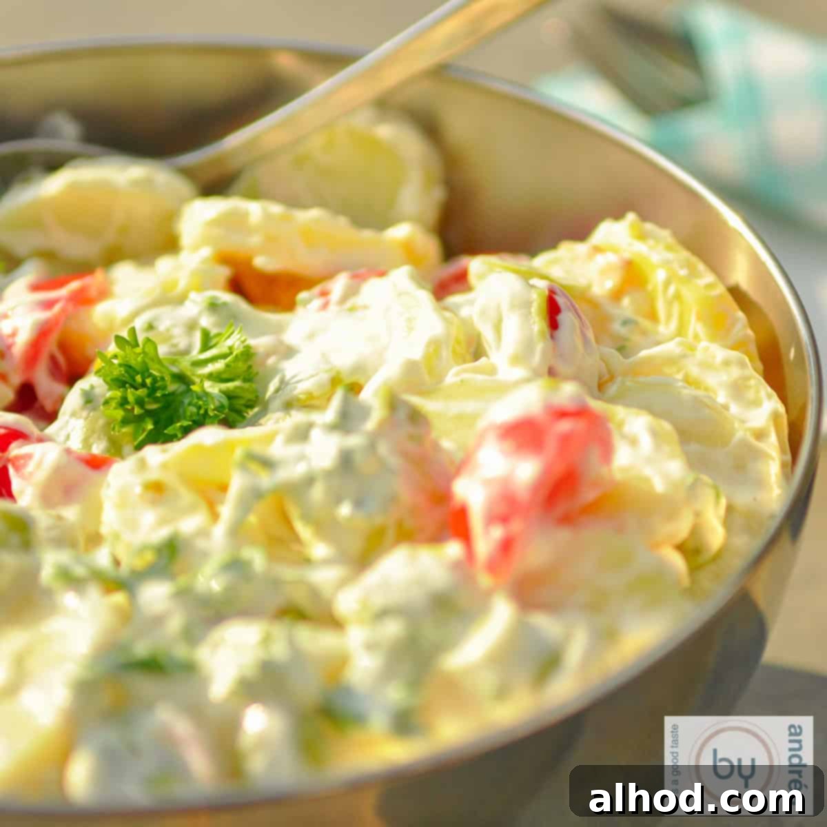 Smoky and Creamy Chicken Potato Salad 4 A stainless steel bowl with slim potato salad on a stone surface