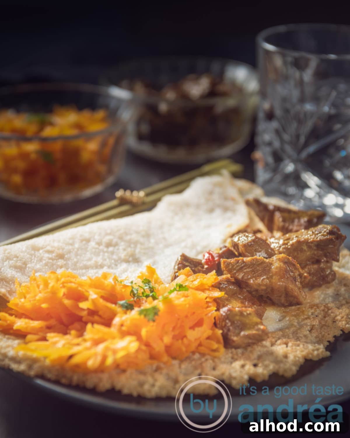 Hoppers & Heat: Sri Lanka's Spiced Beef Curry 2 Appam and curry on a grey plate on a black background, a traditional Sri Lankan meal