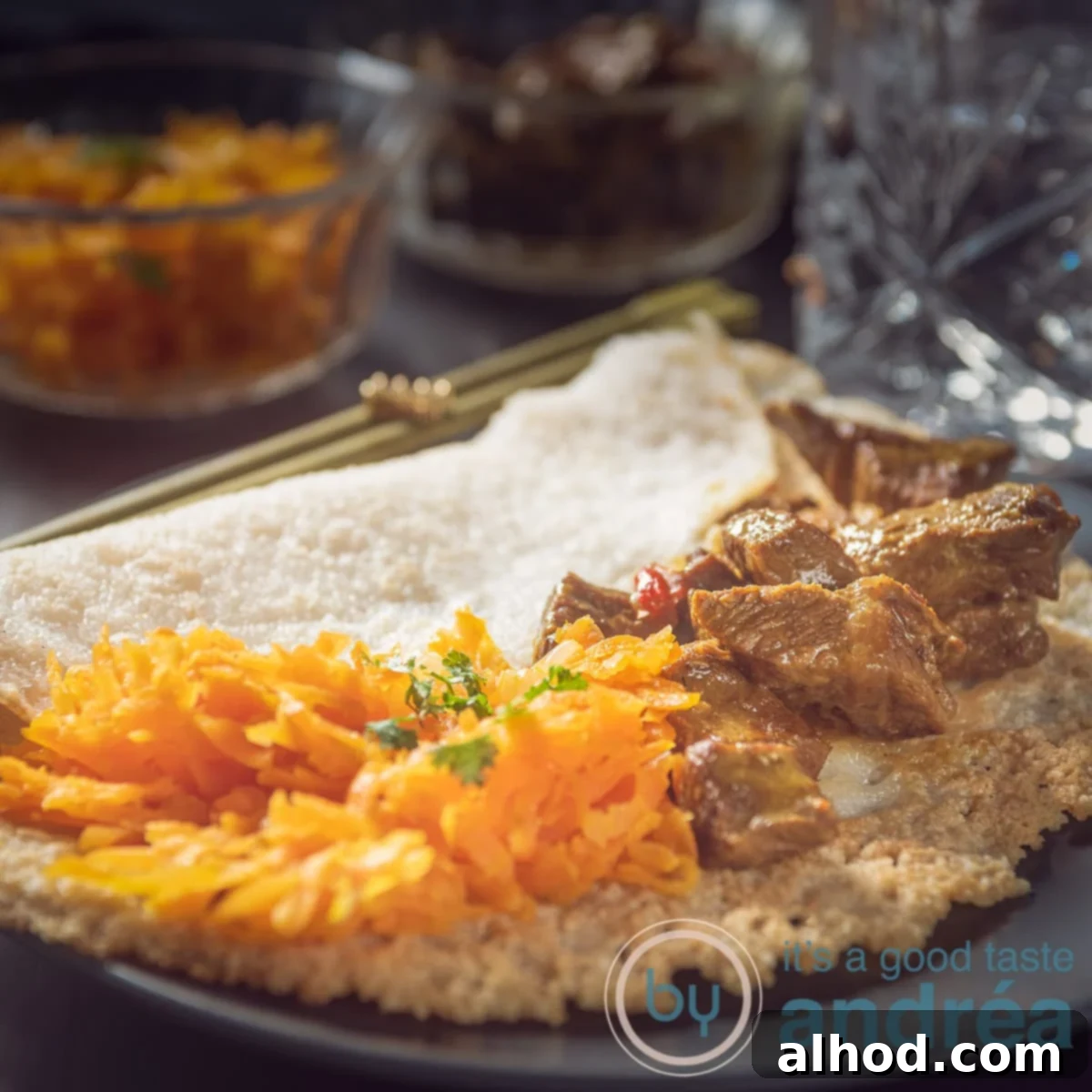 Hoppers & Heat: Sri Lanka's Spiced Beef Curry 10 A square photo with a stuffed appam with braised beef and tropical carrots