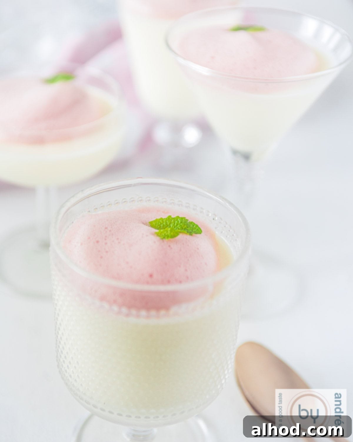 Silky Buttermilk Panna Cotta with Light Berry Foam 2 A couple of glasses of buttermilk panna cotta with berry foam in a glass. This refreshing dessert is easy to make and perfect for any occasion.