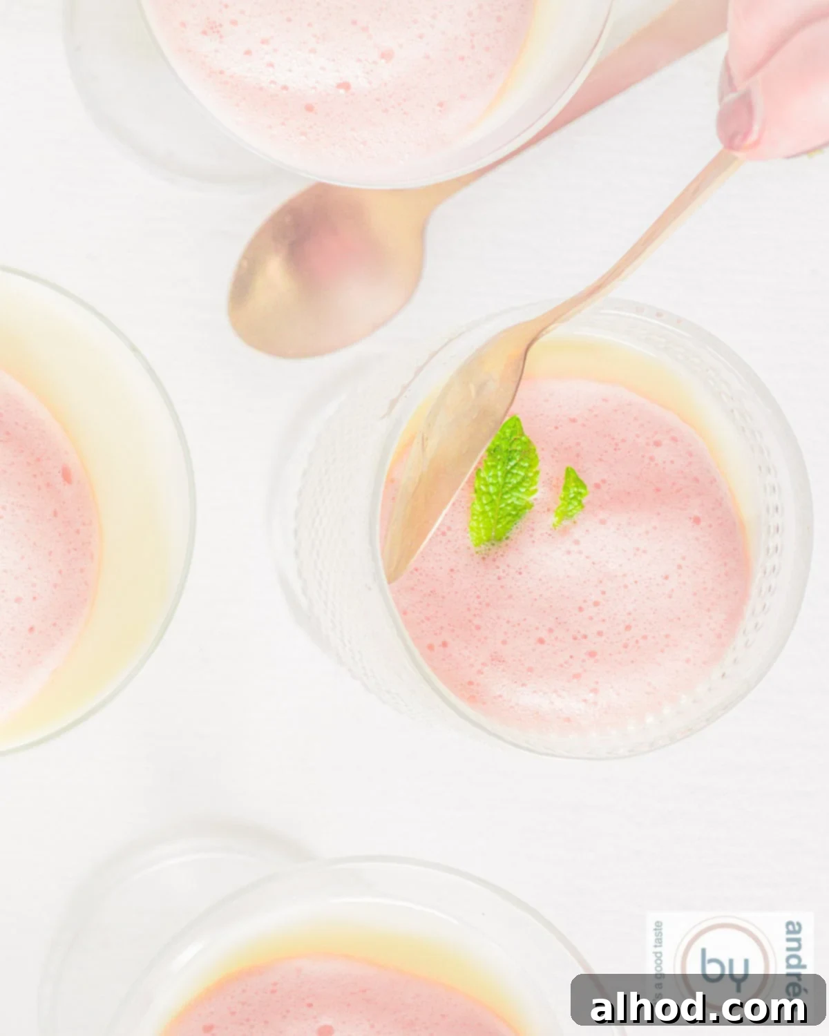 Silky Buttermilk Panna Cotta with Light Berry Foam 3 A top-down photo of glasses of buttermilk panna cotta with berry foam, showcasing its elegant layers and vibrant topping.