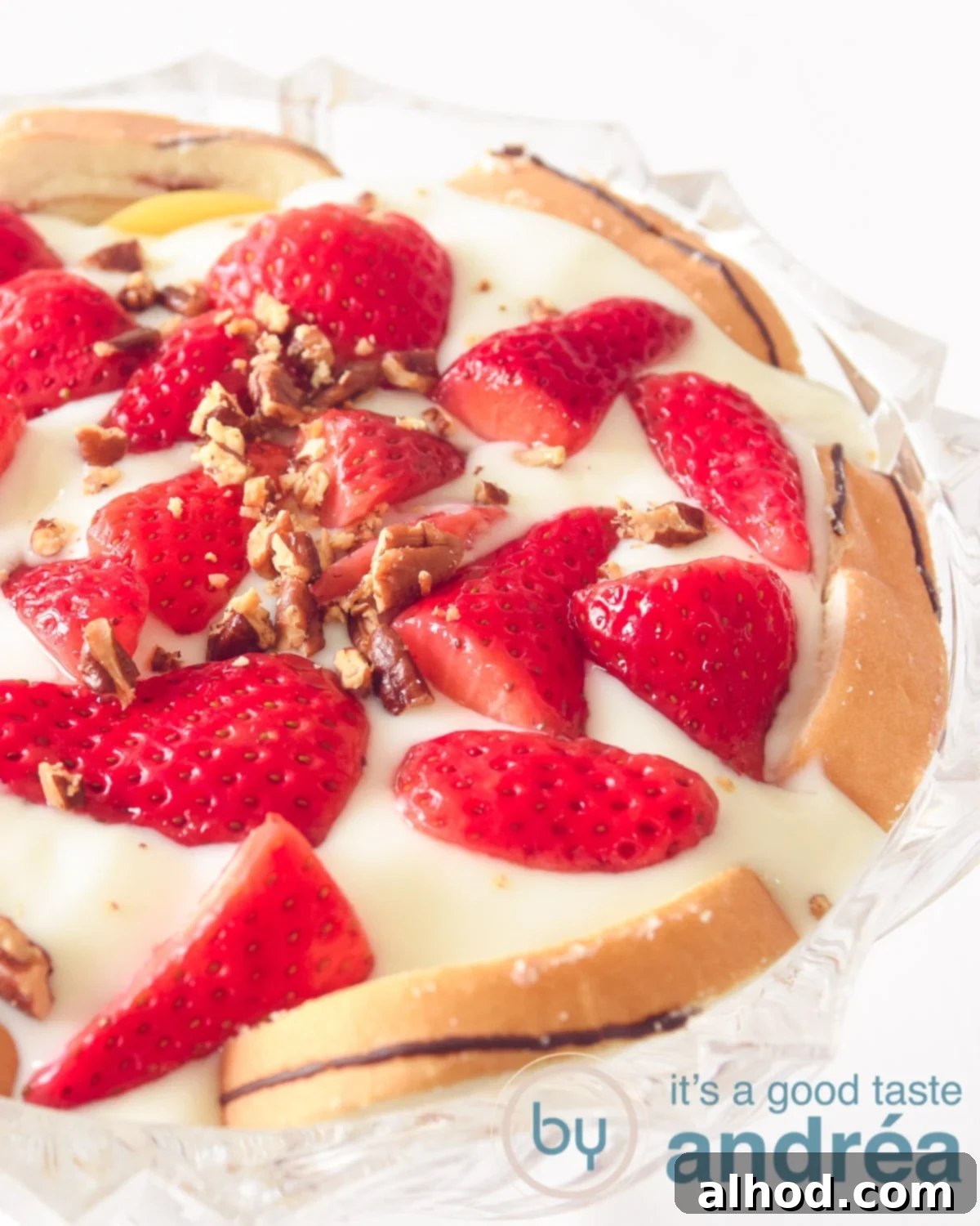 Half a bowl filled with a strawberry trifle with mascarpone cream, strawberries and peach