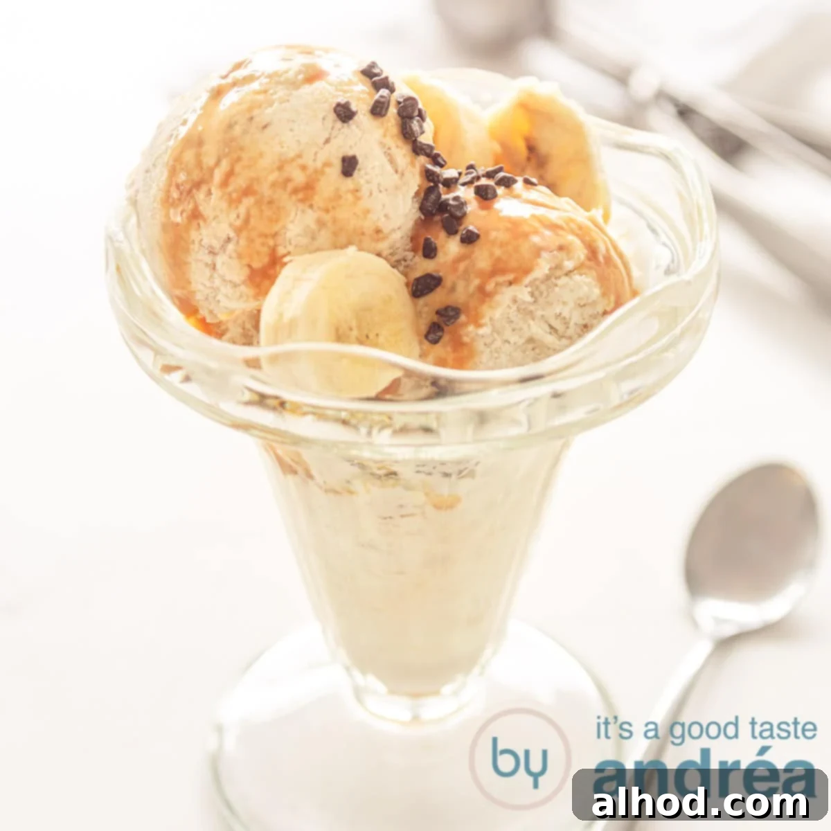 Velvety Homemade Banana Ice Cream 8 A square photo with a glass filled with banana chocolate ice cream and sauce