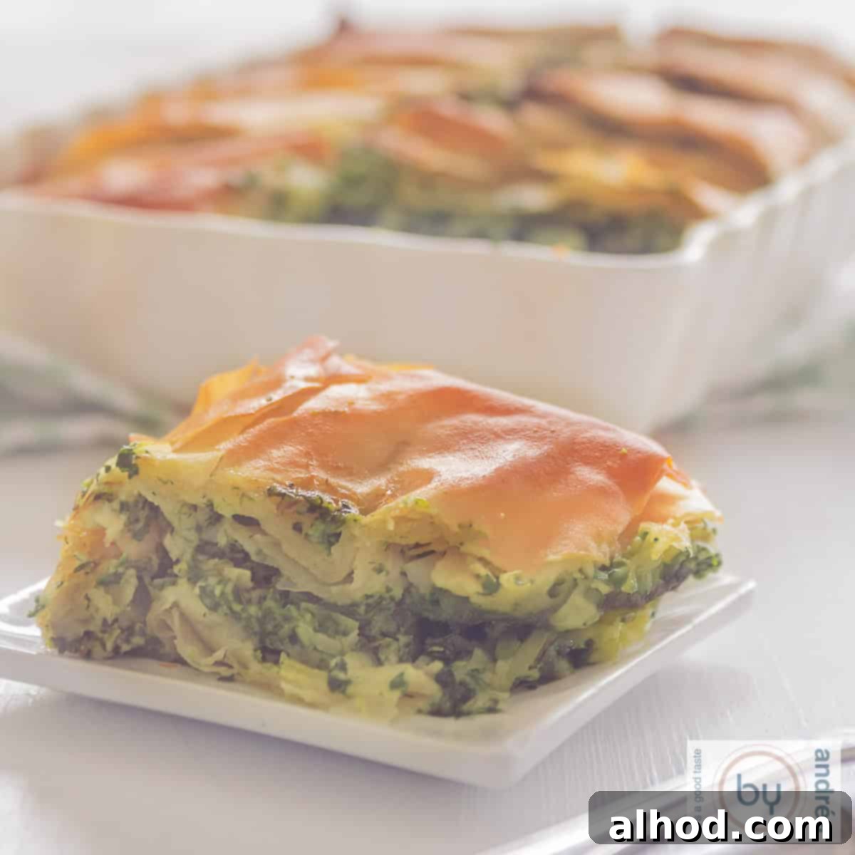 The Easiest Greek Spanakopita Spinach and Feta Pie 4 A square photo with several slices of savory pie with spinach and feta: spanakopita.