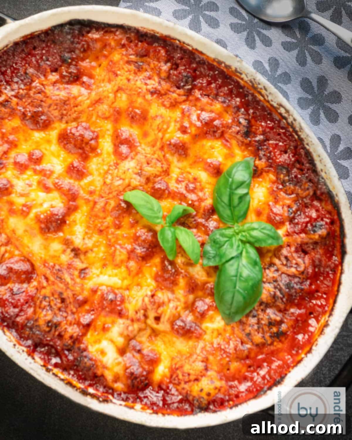 Simple Homemade Lasagna with Hearty Meat Sauce 3 Part of a casserole dish with lasagne with a ground beef sauce and cheeses.