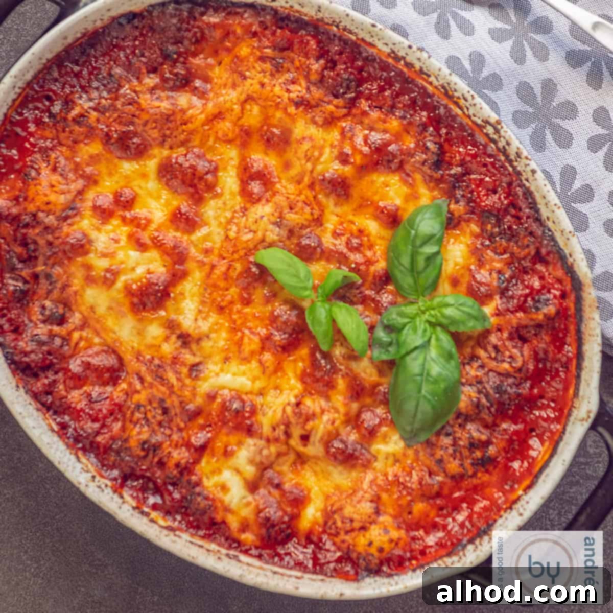 Simple Homemade Lasagna with Hearty Meat Sauce 4 A Square picture from a part of a casserole dish filled with lasagna with bolognese sauce and melted cheeses