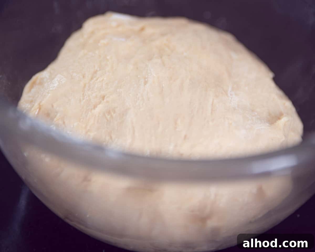 A glass bowl filled with dough