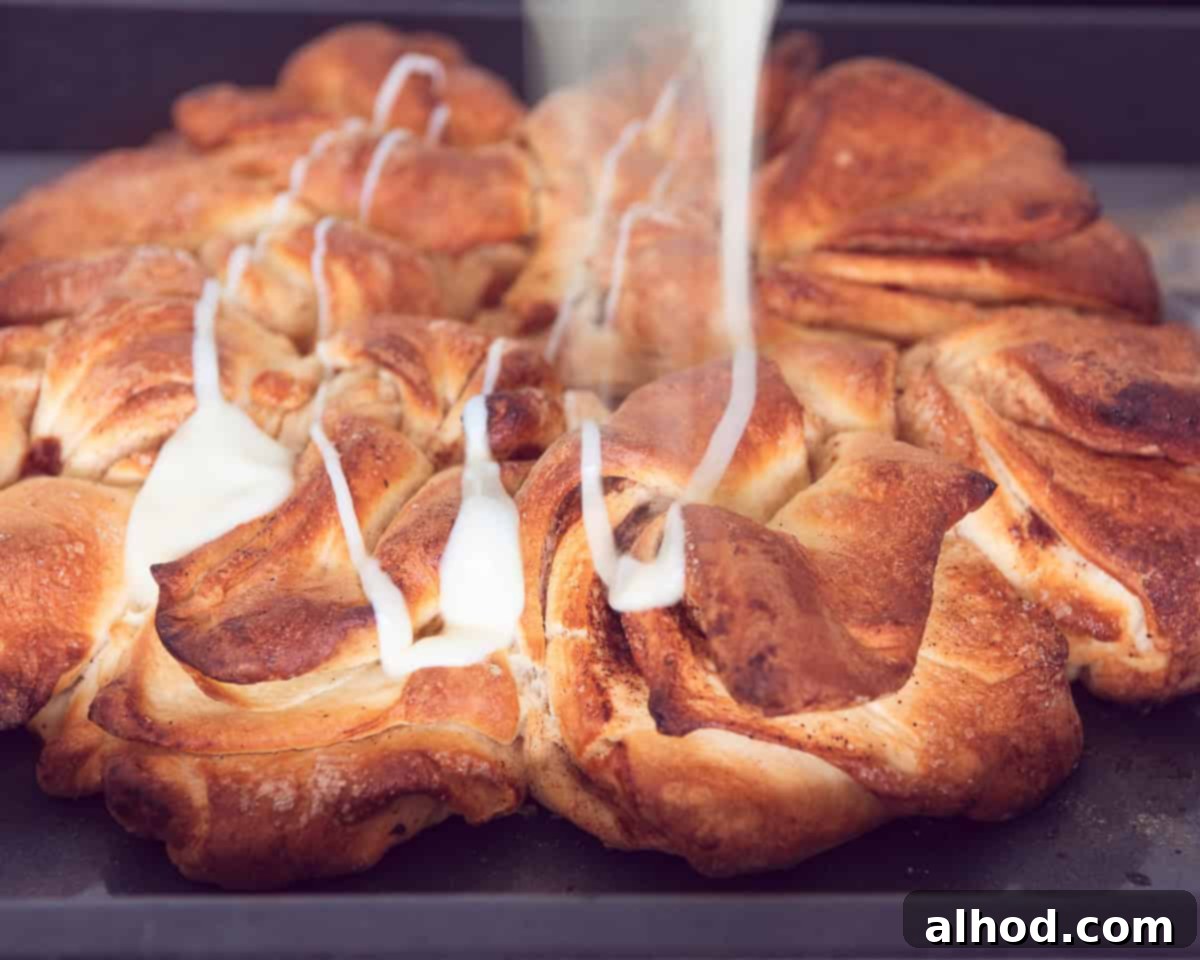 Drizzling sweet condensed milk on top of the baked cinnamon star bread