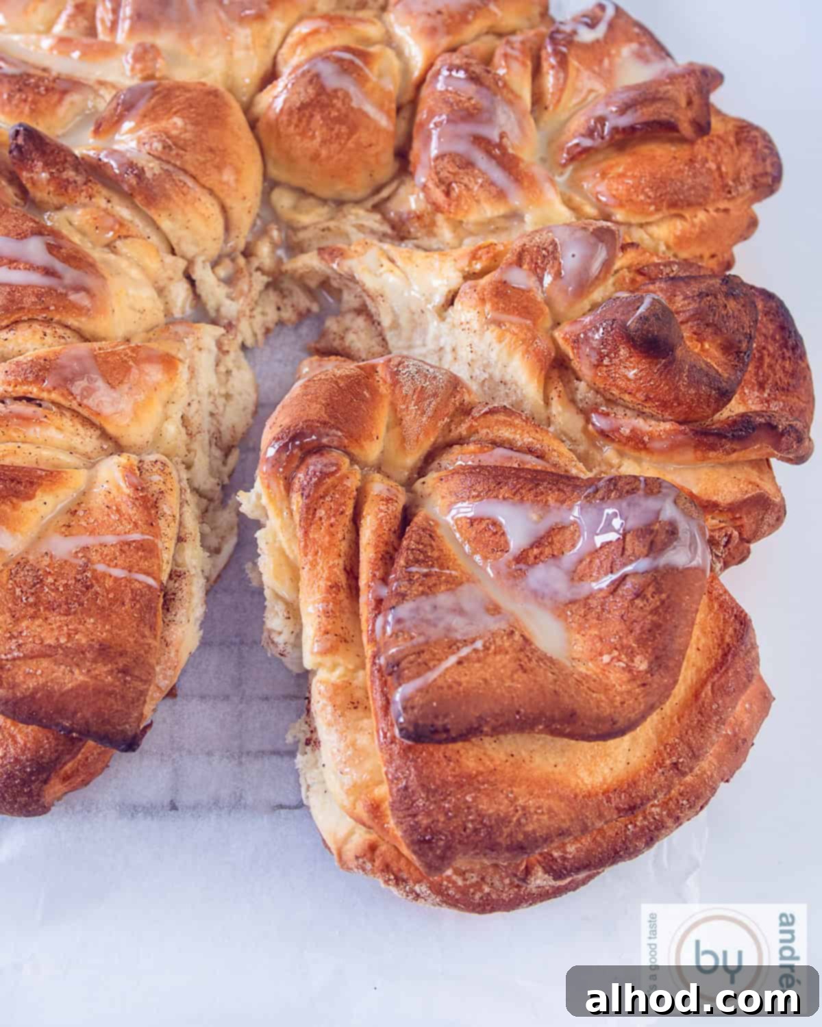 A heigh picture taken top down with a sweet star cinnamon bread on a rack. A slice cut off.
