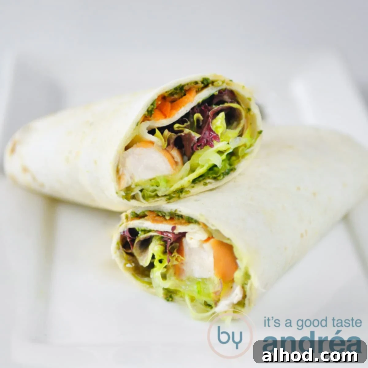 Smoked Chicken Wrap 3 A vibrant close-up of two smoked chicken and veggie wraps, neatly sliced and ready to serve on a rustic wooden board.
