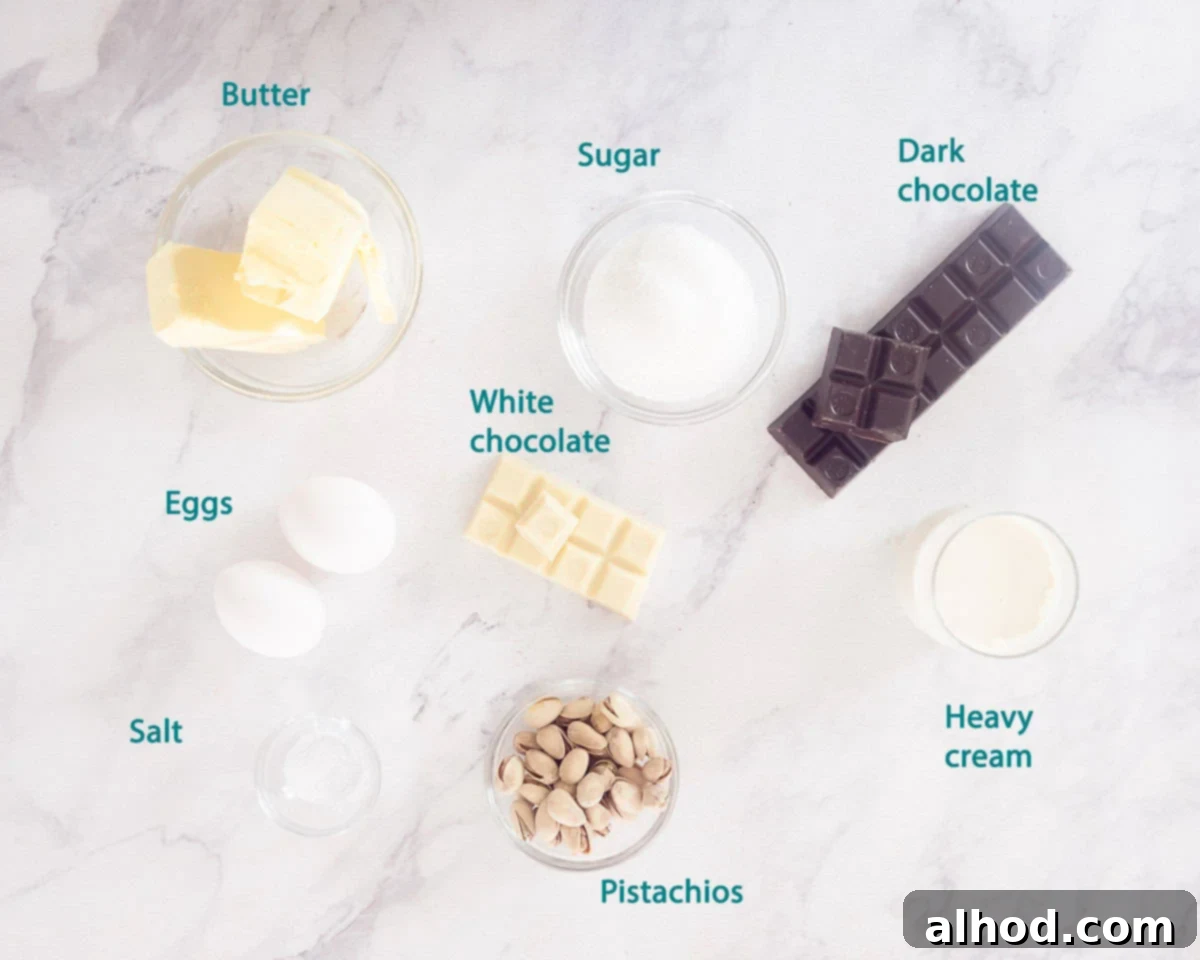 Decadent Triple Chocolate Cupcakes 4 Essential ingredients for the Triple Chocolate Cupcakes ganache and topping, including dark chocolate, heavy cream, pistachios, egg whites, sugar, and butter, artfully arranged on a white background.