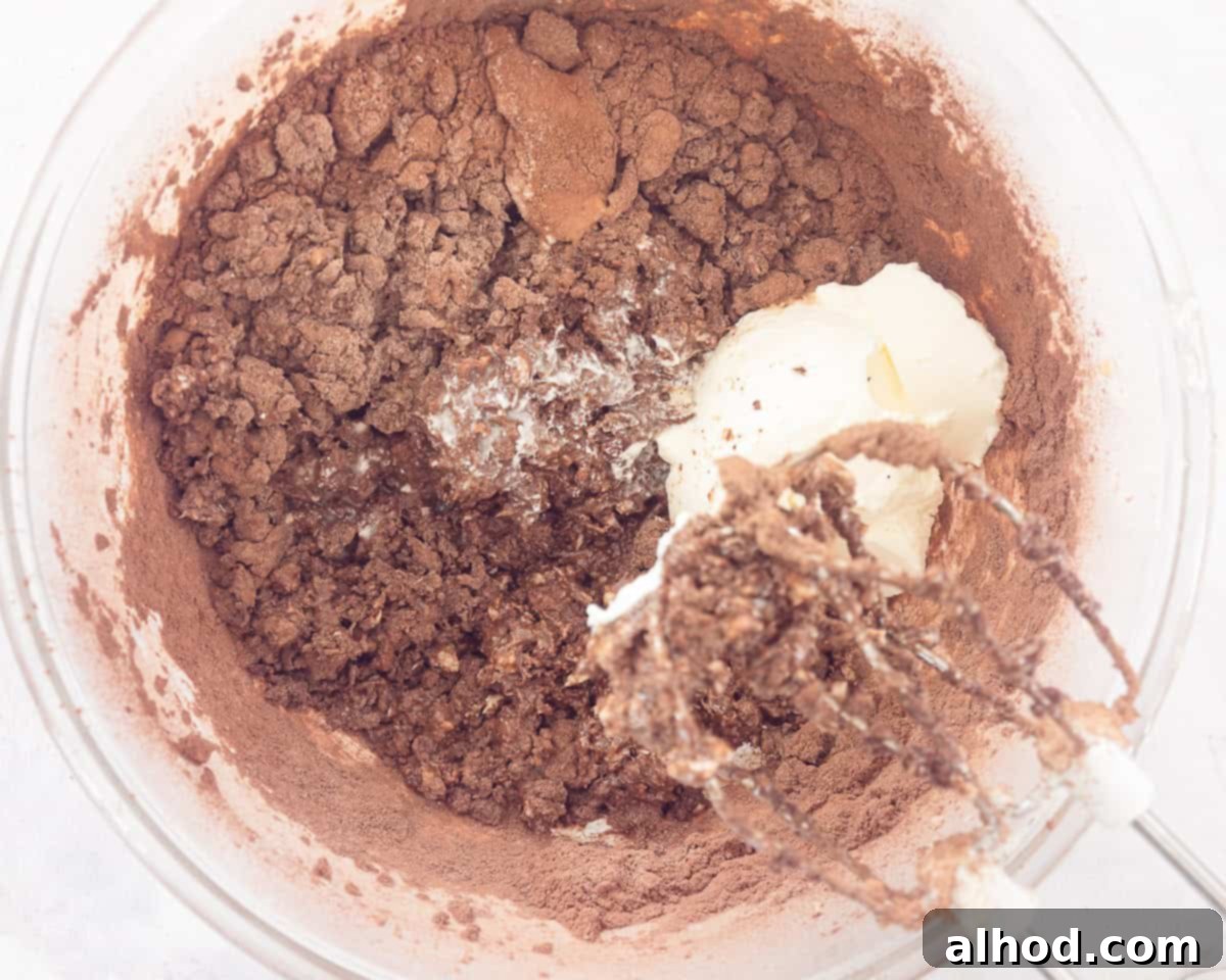 Decadent Triple Chocolate Cupcakes 5 A mixing bowl filled with rich, dark chocolate cupcake batter, ready to be scooped into liners.
