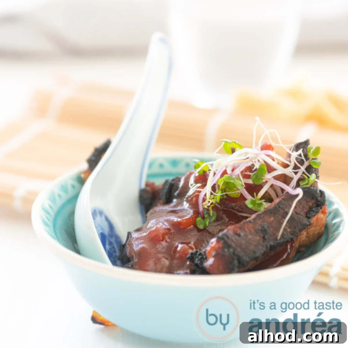 Authentic Chinese Babi Pangang Recipe 9 Square photo of crispy Babi Pangang in a blue bowl, garnished with fresh scallions.