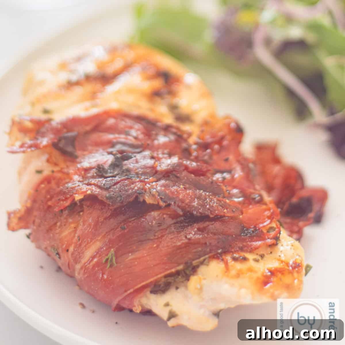 Easy BBQ Tuscan Chicken and Serrano Ham 4 A square photo of a chicken fillet with Italian herbs wrapped in Serrano ham