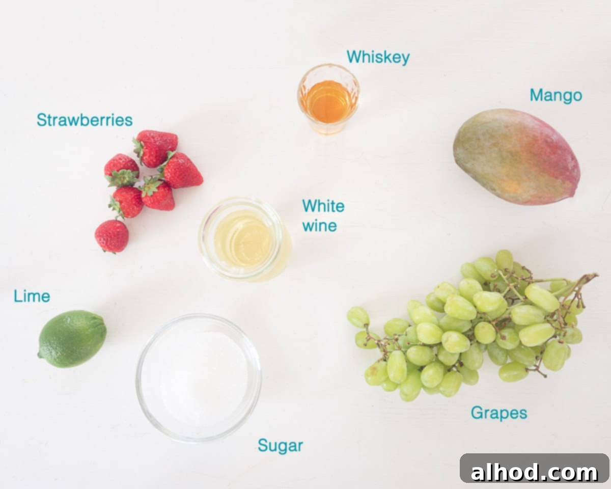 Crafting the Perfect Clerico Punch 3 A collage of fresh ingredients laid out on a white background, including sliced mango, strawberries, green grapes, a bottle of white wine, a bottle of whiskey, a lime, and a bowl of sugar, all ready for the Clerico recipe.