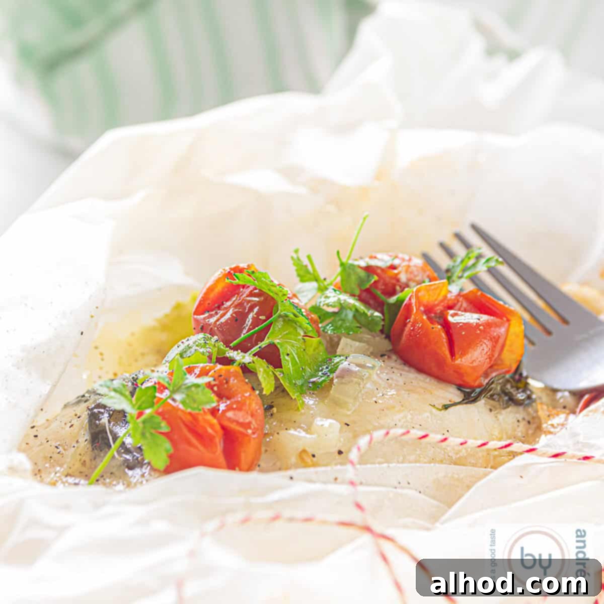 Cod en Papillote 4 A square photo with an open baking paper filled with fried cod with cheese and vegetables